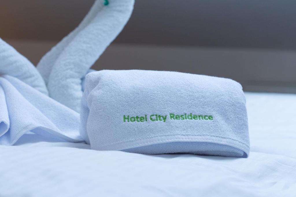 a towel on a bed with the words hotel city resistance at Hotel City Residence in Vienna