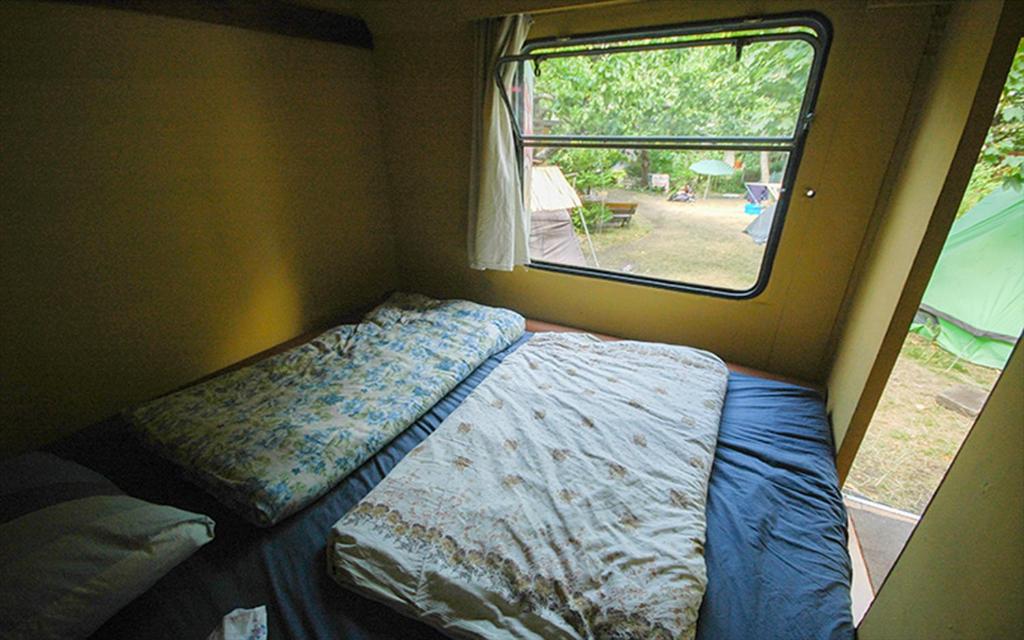 Postel nebo postele na pokoji v ubytování Sandino Summer Camp