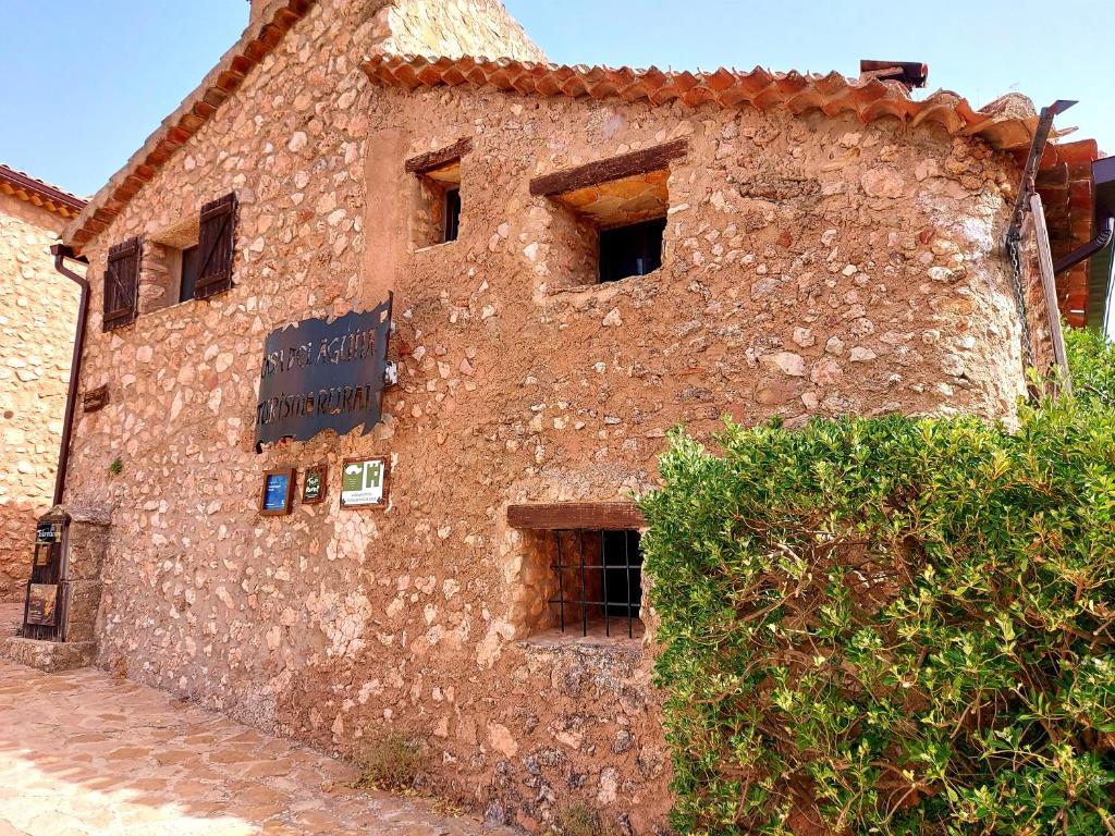 an old brick building with a sign on it at Casa del Águila del Valle in Riópar Viejo