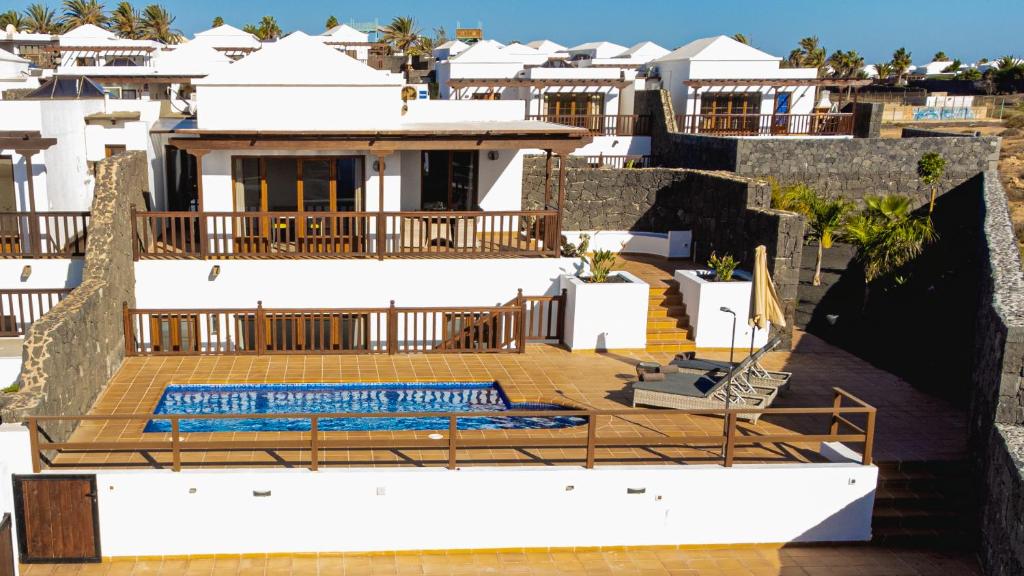 a house with a swimming pool on a deck at Villa DaVinci - Playa Blanca in Playa Blanca