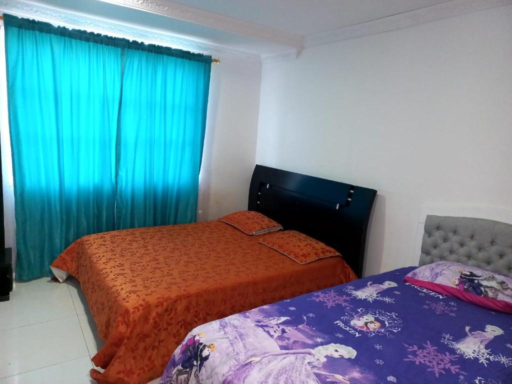 Llit o llits en una habitació de Casa confortable santa marta-osman
