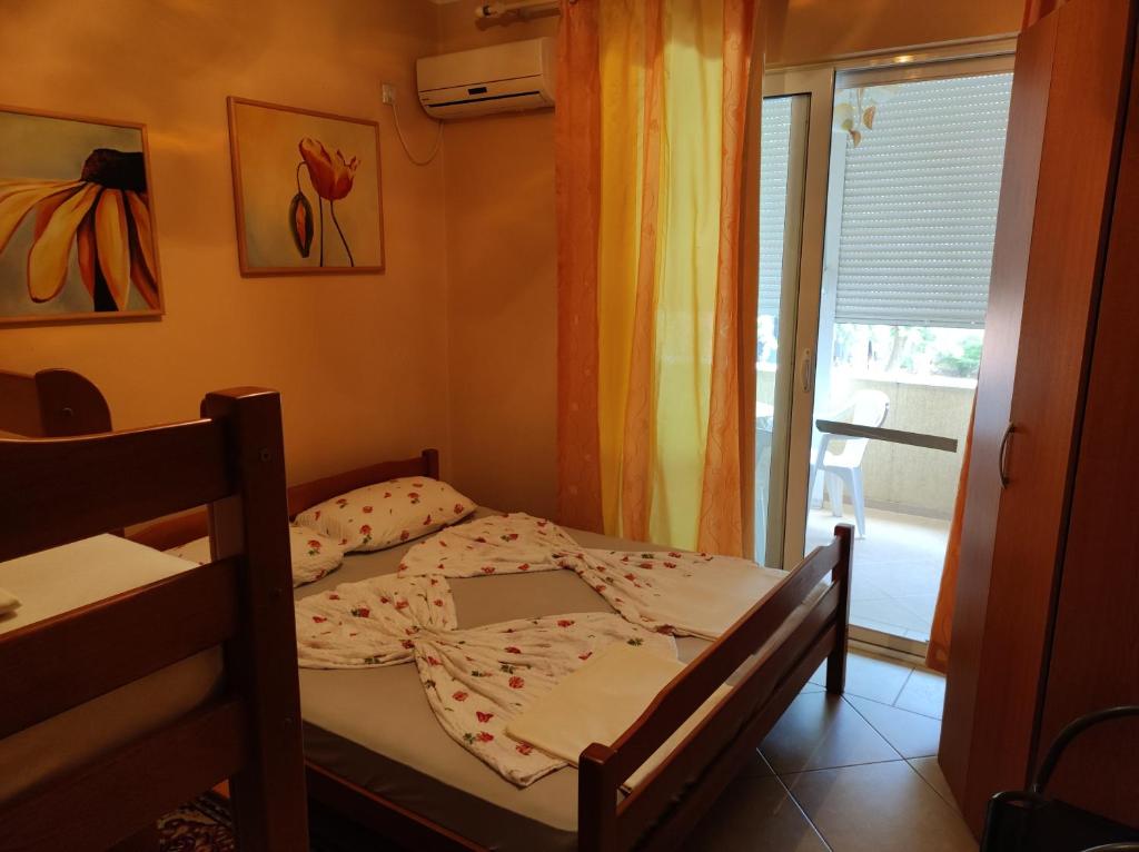 a small bedroom with a bed and a window at Sinanovic Rooms in Ulcinj