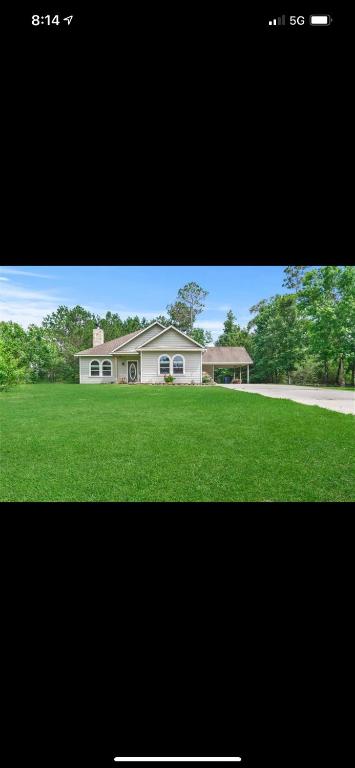 a picture of a house with a green lawn at Little House on the Corner in Livingston