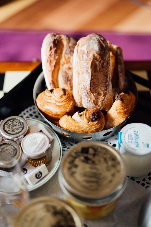 a plate of bread and pastries on a table at Dormy House in Étretat