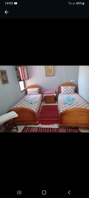 a room with two beds in a room at Calmeplace in El Jadida