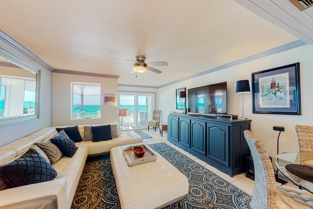 a living room with a couch and a tv at Costa Del Sol C1- Scenic Sands in Destin