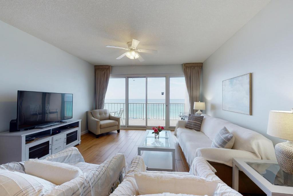 a living room with a couch and a tv at TOPS'L Tides 704 in Destin