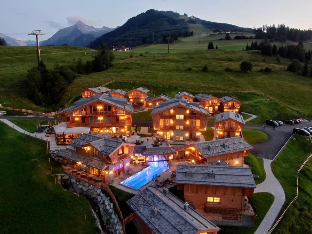 an aerial view of a large house with lights on at Chalet Village Zaglgut - Summercard Zell am See-Kaprun included in Kaprun