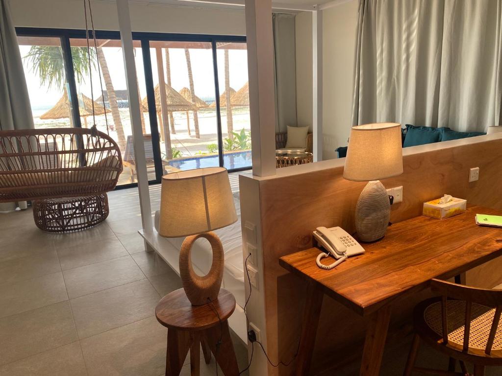a room with a desk with a phone on it at TOA Hotel & Spa Zanzibar in Pongwe