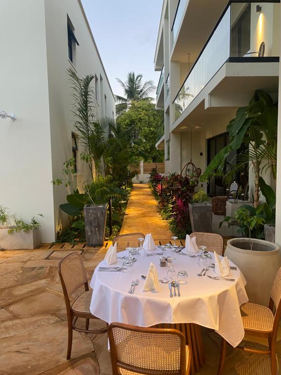 a table with a white table cloth on a patio at TOA Hotel & Spa Zanzibar in Pongwe