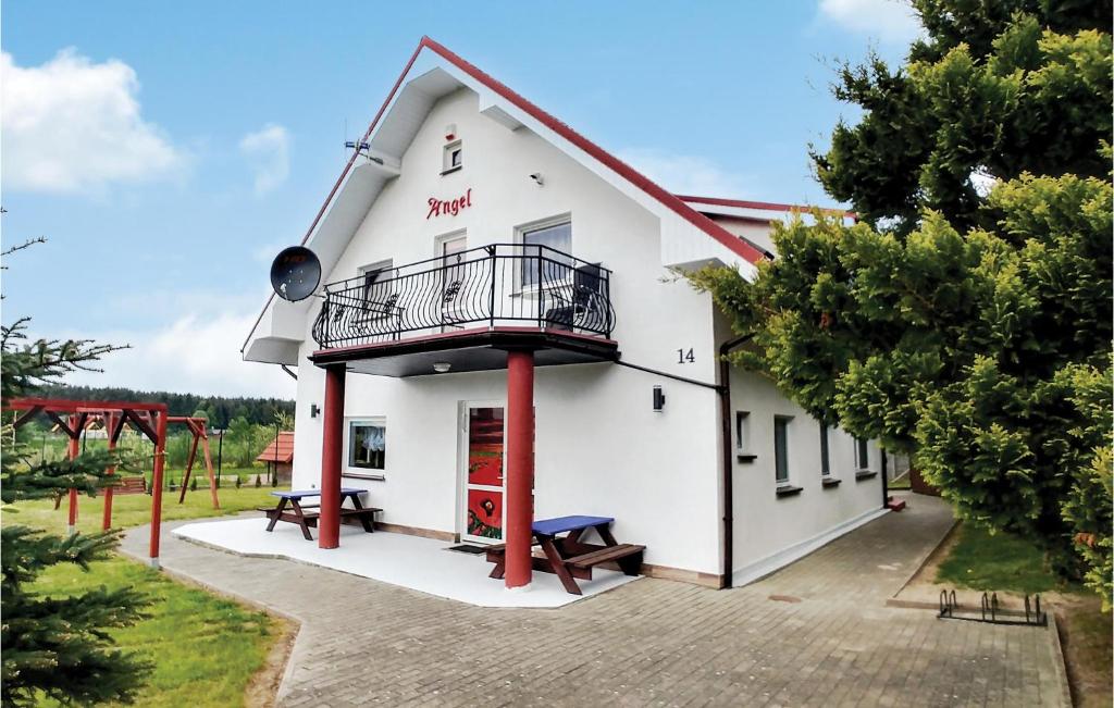 a building with a balcony and a playground at Gorgeous Home In Rusinowo With Wifi in Jarosławiec