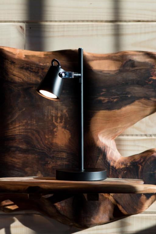 a black lamp sitting on a table in front of a painting at NI-NEWEN Hotel & Lodge in Pucón