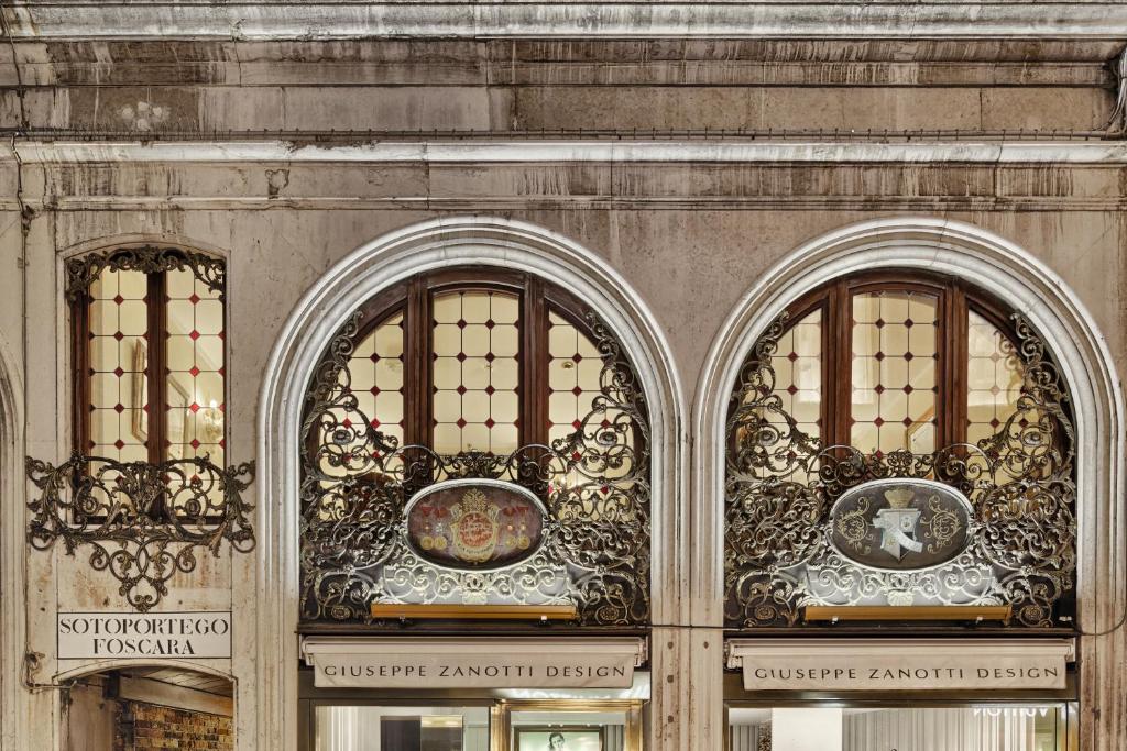 a building with three arched windows on it at Hotel Firenze in Venice