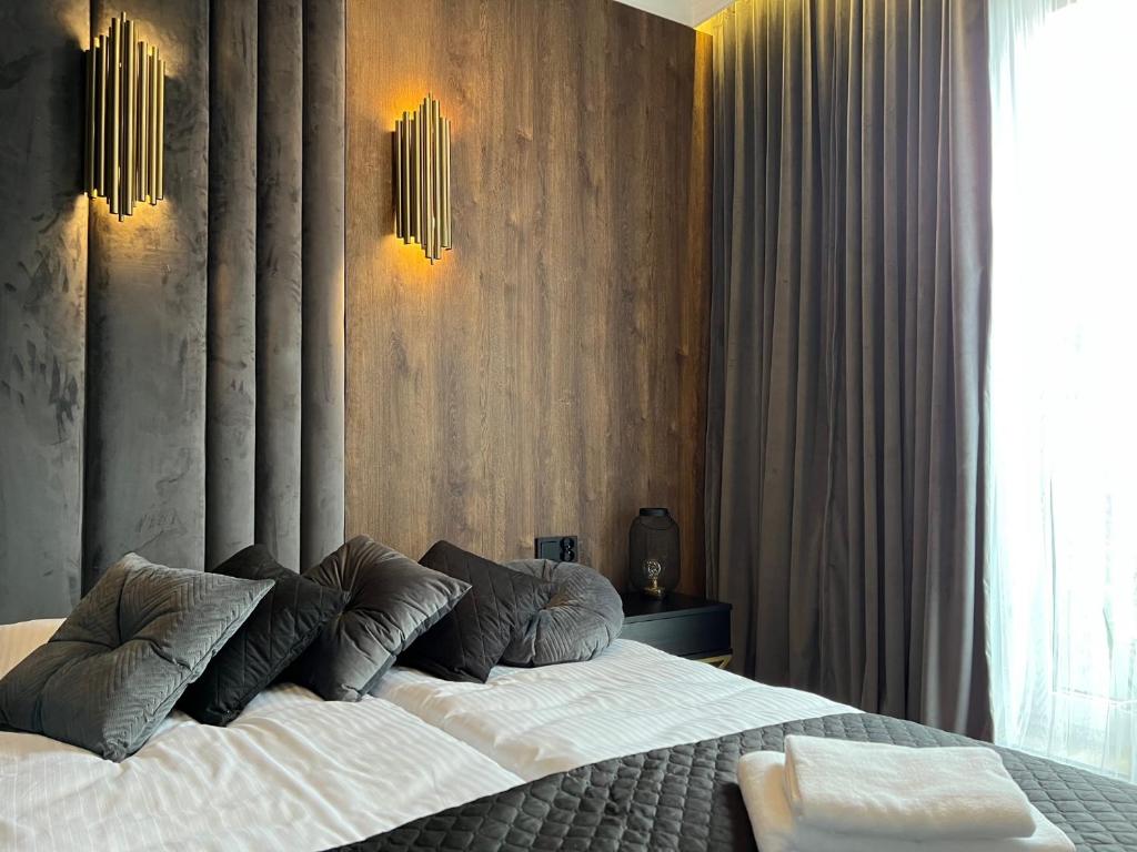 Un dormitorio con una cama con dos almohadas encima. en Family & Business Sauna Tężnia Apartments No 10 VIP -Leśny nad Zalewem Cedzyna, Unikat SPA- 1 Bedroom with Private Sauna, Jacuzzi, Spectacular View Terrace, Parking, Catering Options, en Kielce
