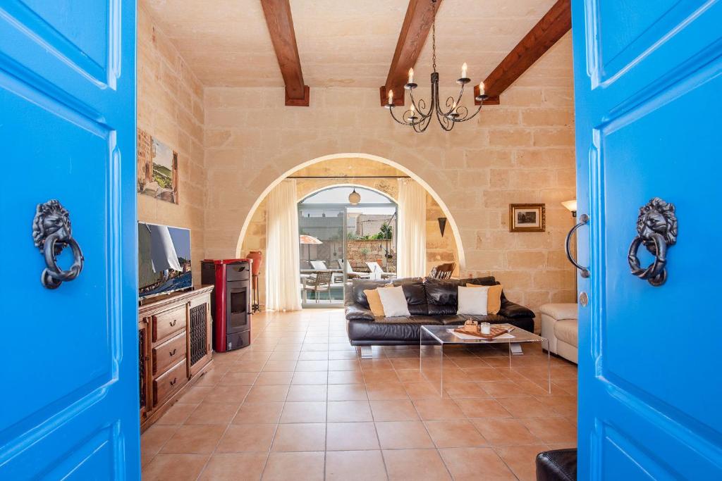 een woonkamer met een bank en een tafel bij Ta Indri Holiday Home in Żebbuġ