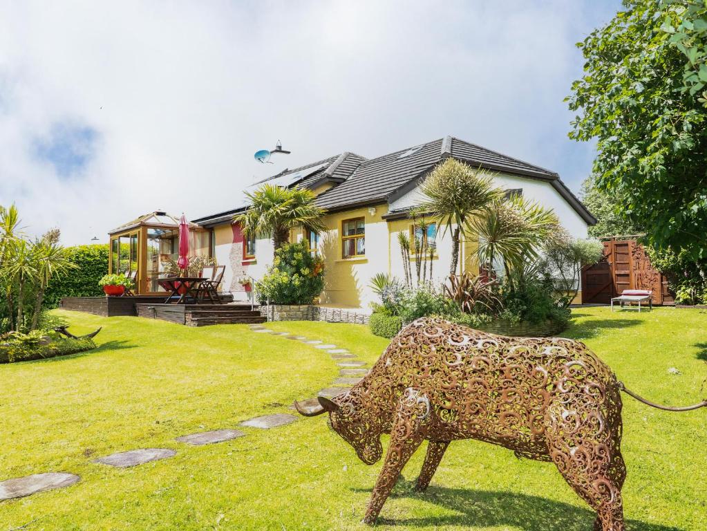 a statue of a cow in front of a house at Marina House in Enniskillen