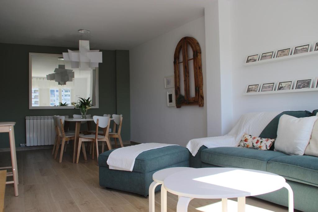 a living room with a couch and a table at Apartamento completamente reformado en el casco antiguo con vistas al rio in Balaguer