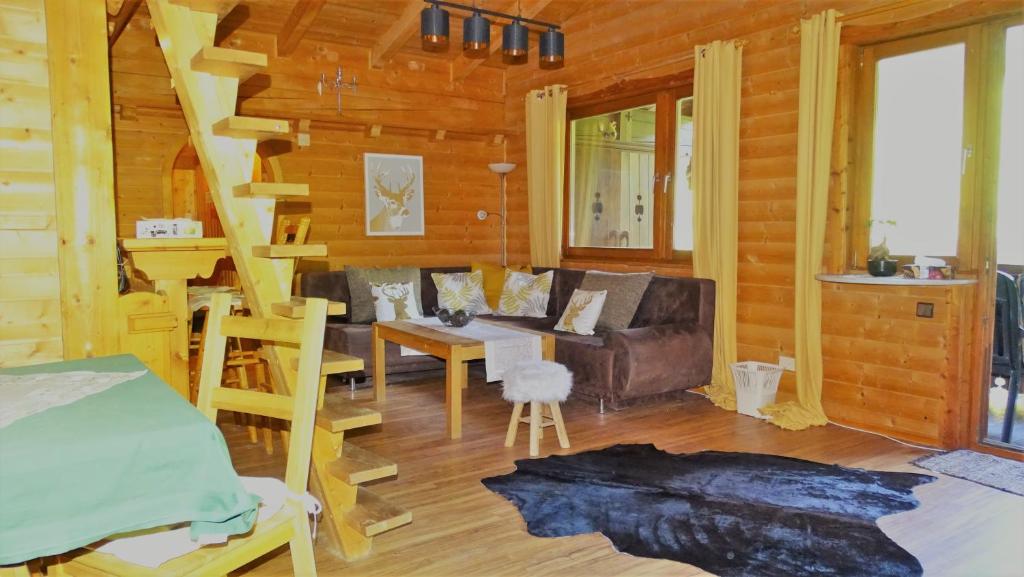 a living room with a couch and a table at Luxusapartment im Landhaus Brugger in Mühlbach