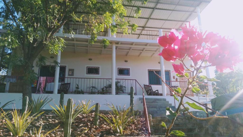 a house with a pink flower in front of it at Casa Todo Bueno in Transito