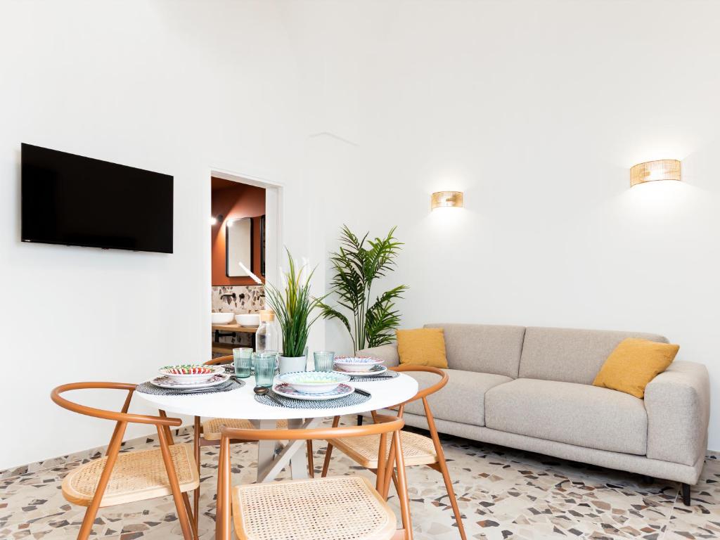 a living room with a couch and a table at Cally Suite Room in Martina Franca