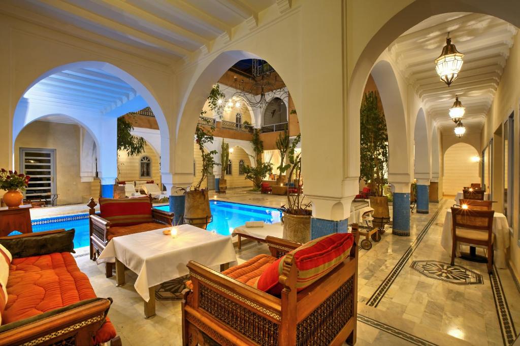 a large room with a swimming pool in a building at Ksar Anika Boutique Hotel & Spa in Marrakech