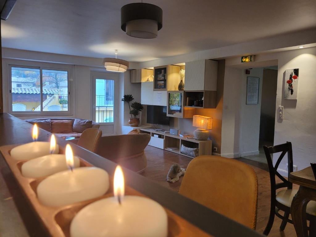 a living room with lit candles on a table at Hôtel Restaurant Le Lachens in La Bastide