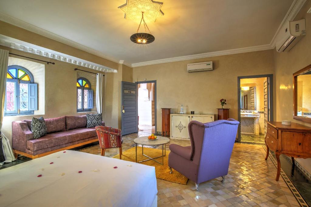 a living room with a couch and a table at Ksar Anika Boutique Hotel & Spa in Marrakech