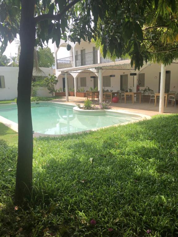 a swimming pool in the yard of a house at le HBR de Saly in Saly Portudal