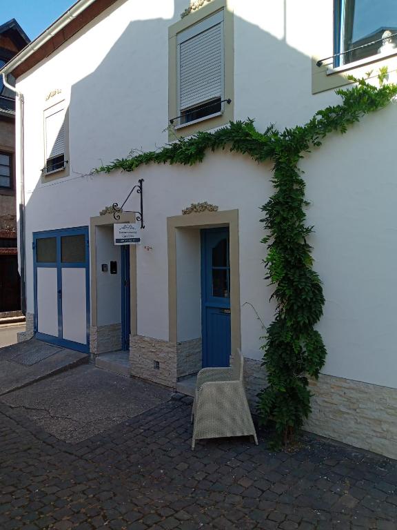 a building with a chair sitting outside of it at Casa Livia in Lieser
