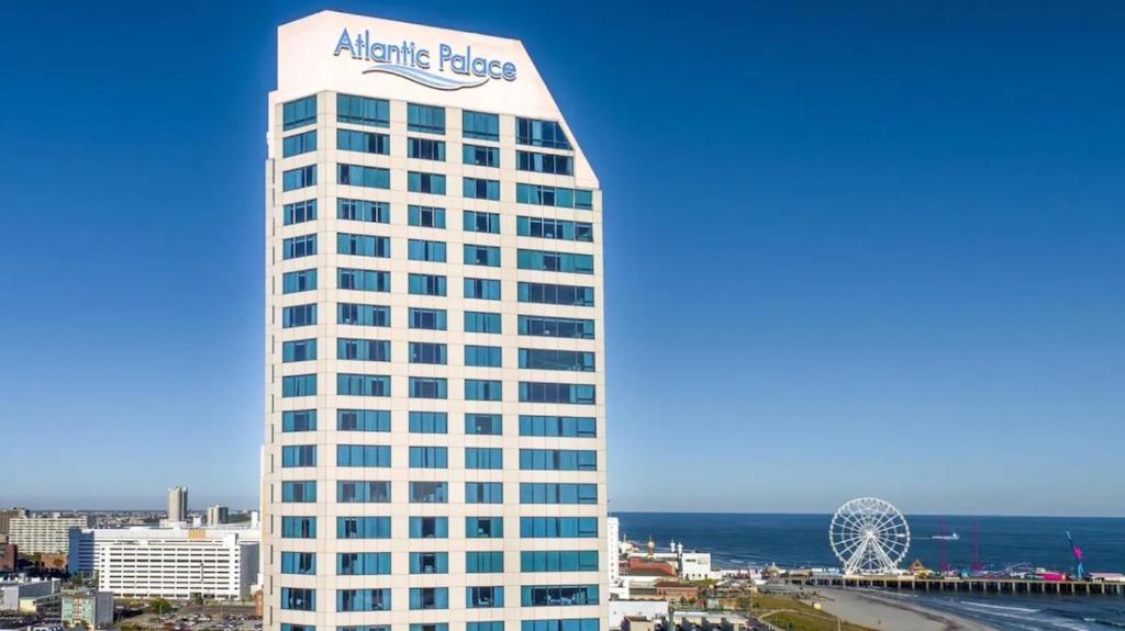 a tall white building with an atlantic palace sign on it at Boardwalk Resorts at Atlantic Palace in Atlantic City