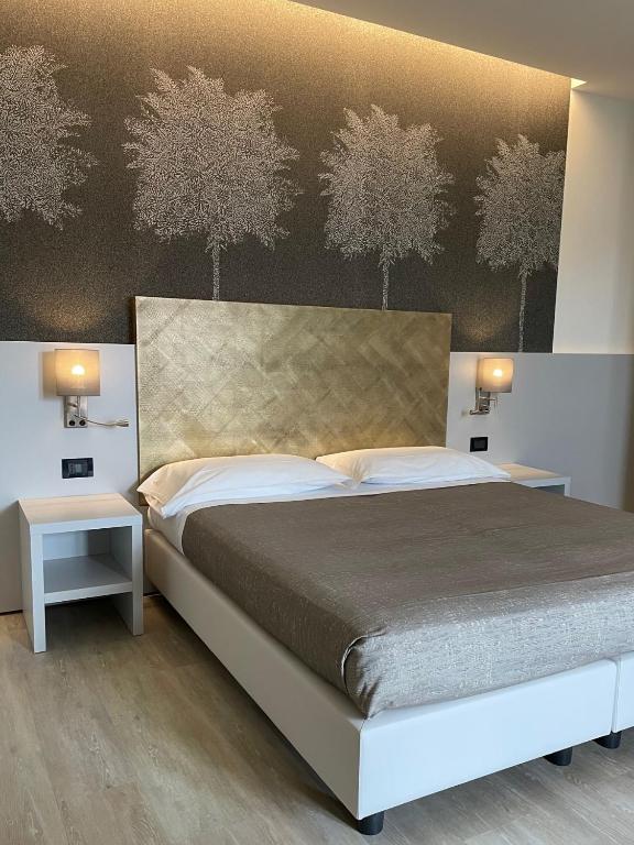Postel nebo postele na pokoji v ubytování Hotel Tritone
