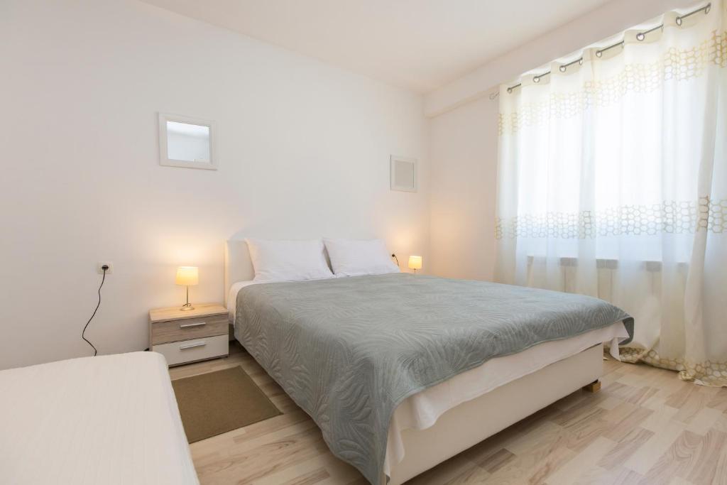 Postel nebo postele na pokoji v ubytování Apartmani Xenia & Desiderio