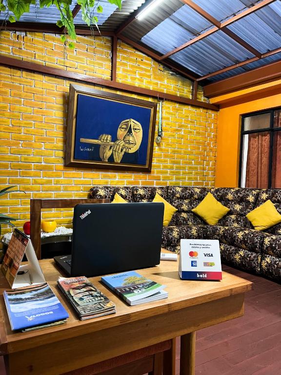 a table with a laptop and books on it at Hostal Casa del Café in Bogotá