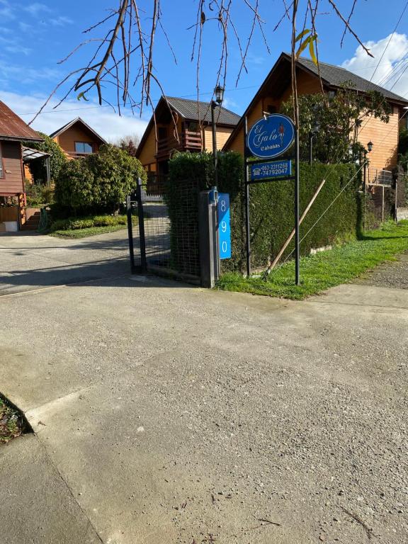 a house with a sign on the side of a street at Cabañas El Galo in Panguipulli