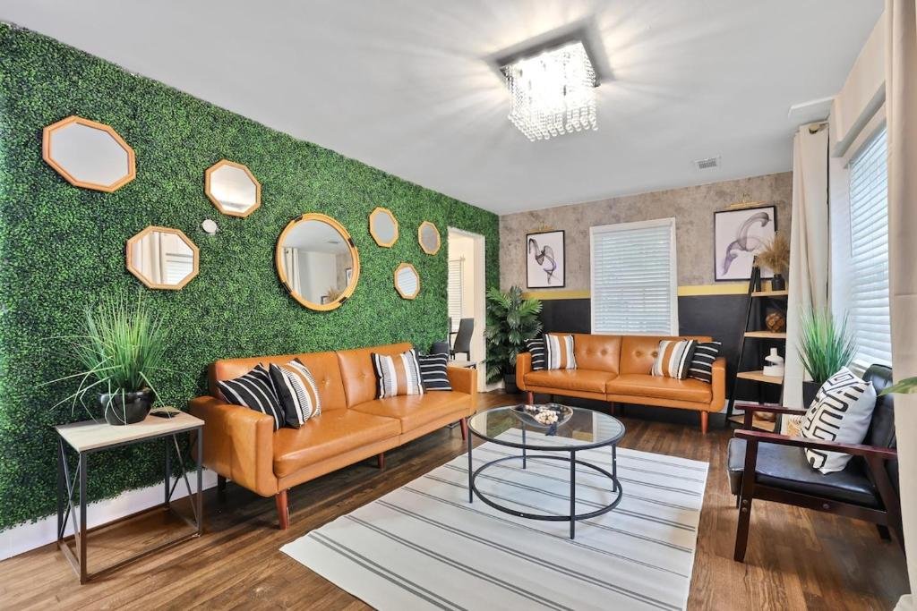 a living room with orange furniture and a green wall at Atlanta Retreat Message For Spring Special in Atlanta