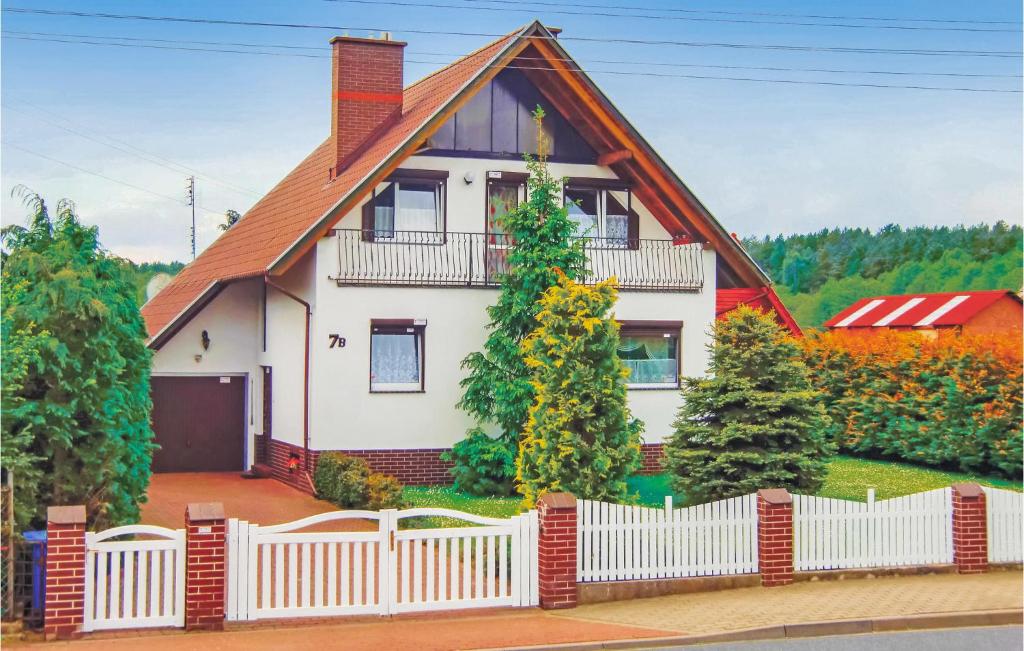 a white house with a white picket fence at Amazing Home In Kolczewo With Sauna in Kołczewo