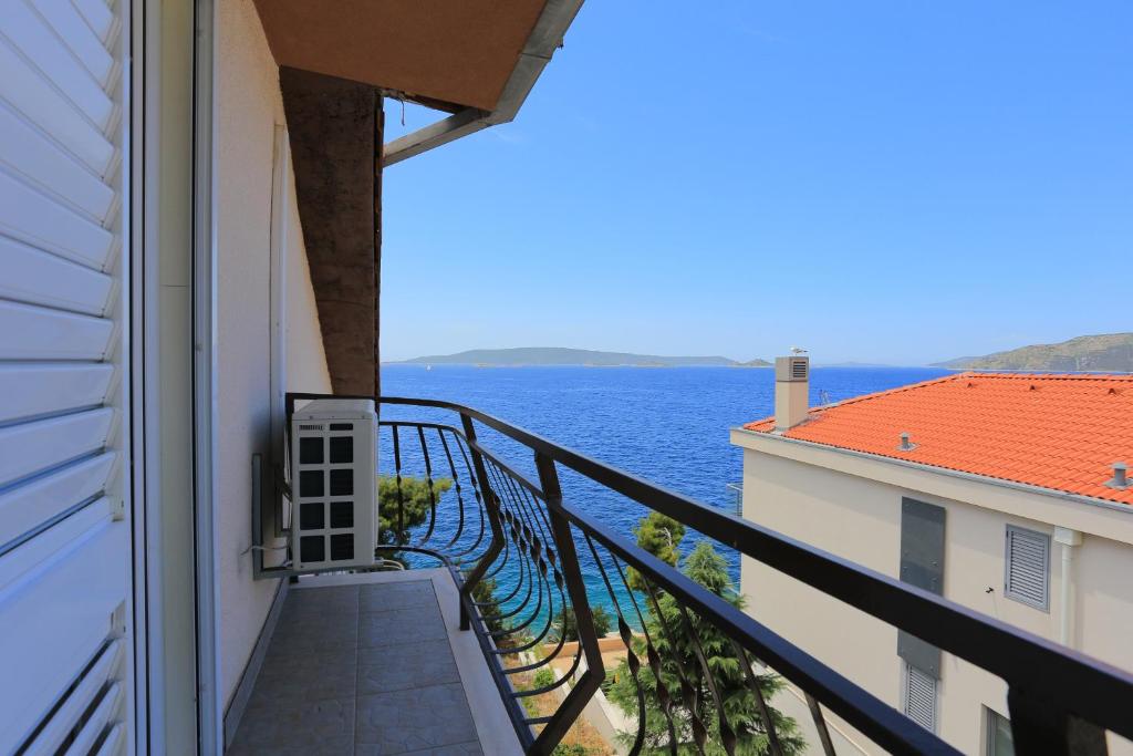 a balcony with a view of the ocean at Apartment Okrug Donji 16657b in Okrug Donji