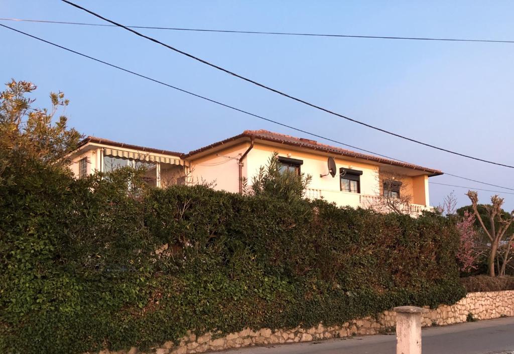 a house sitting on top of a hill at Apartments with a parking space Barbat, Rab - 16723 in Rab