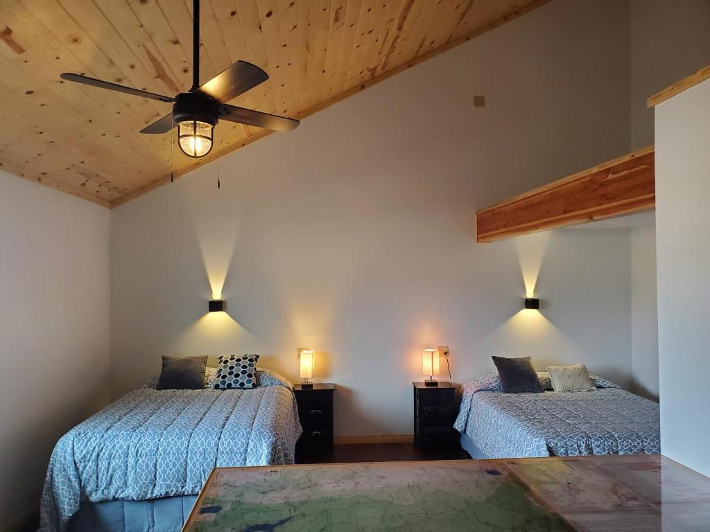 a bedroom with two beds and a ceiling fan at Dream Drift Motel in Cameron