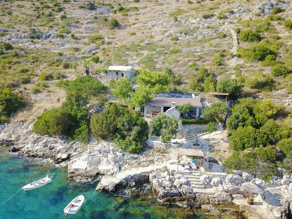 an aerial view of a house with boats in the water at Secluded fisherman's cottage Cove Spiljice, Brac - 17031 in Selca
