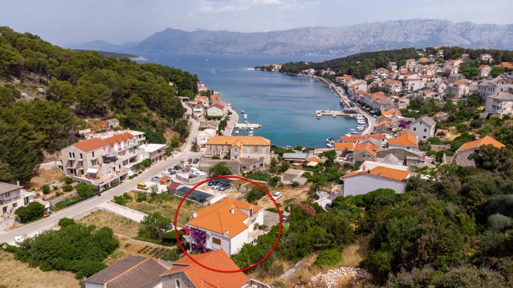 an aerial view of a town with a red circle at Apartments by the sea Povlja, Brac - 16792 in Povlja