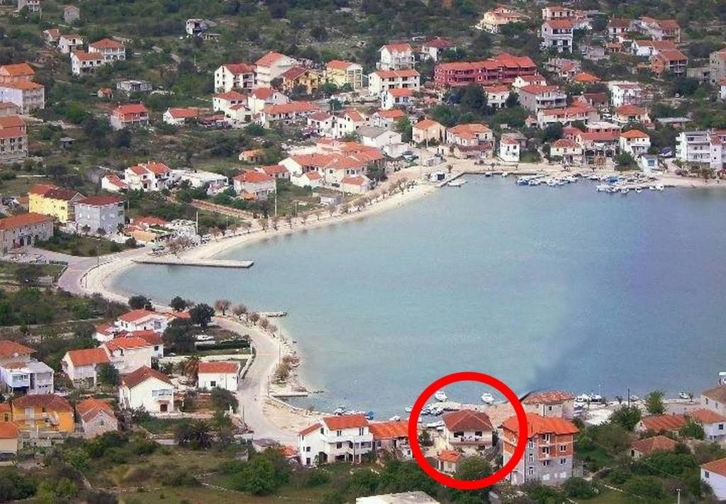 a beach with a red circle in the middle at Apartments by the sea Vinisce, Trogir - 16860 in Vinišće