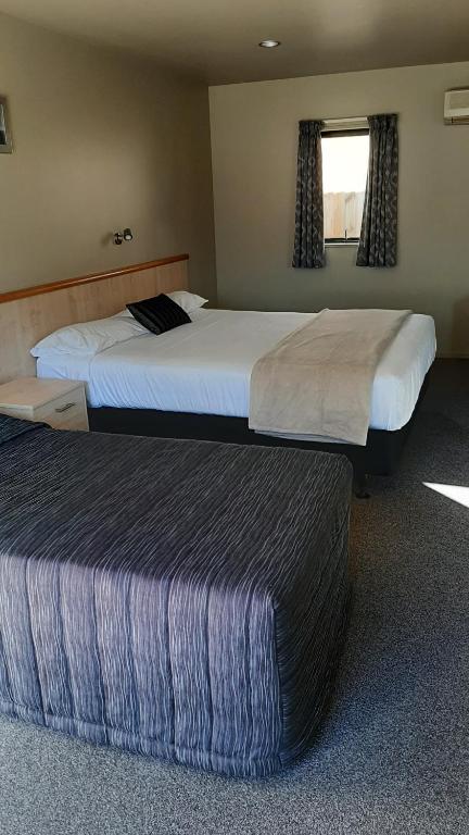Postel nebo postele na pokoji v ubytování Kaikoura Gateway Motor Lodge