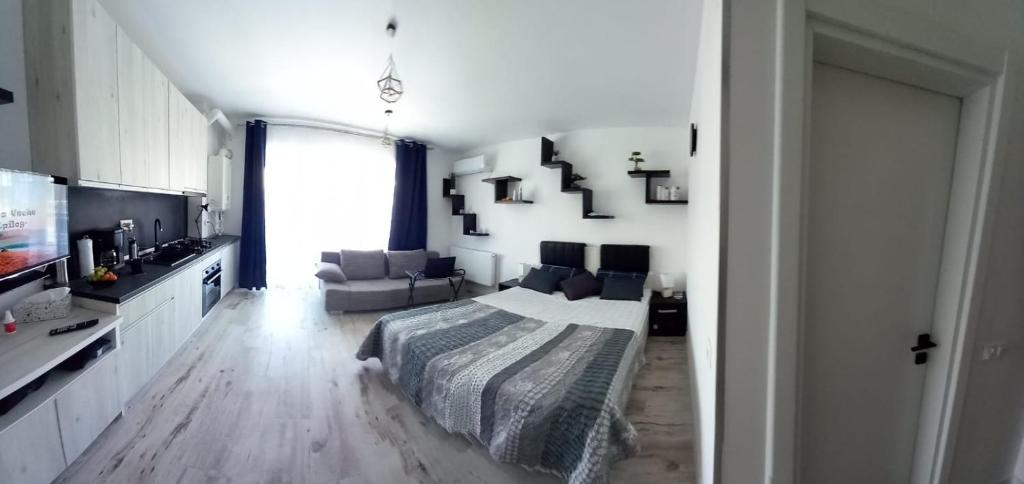 a bedroom with a bed and a living room at Garsoniera Saturn in Saturn