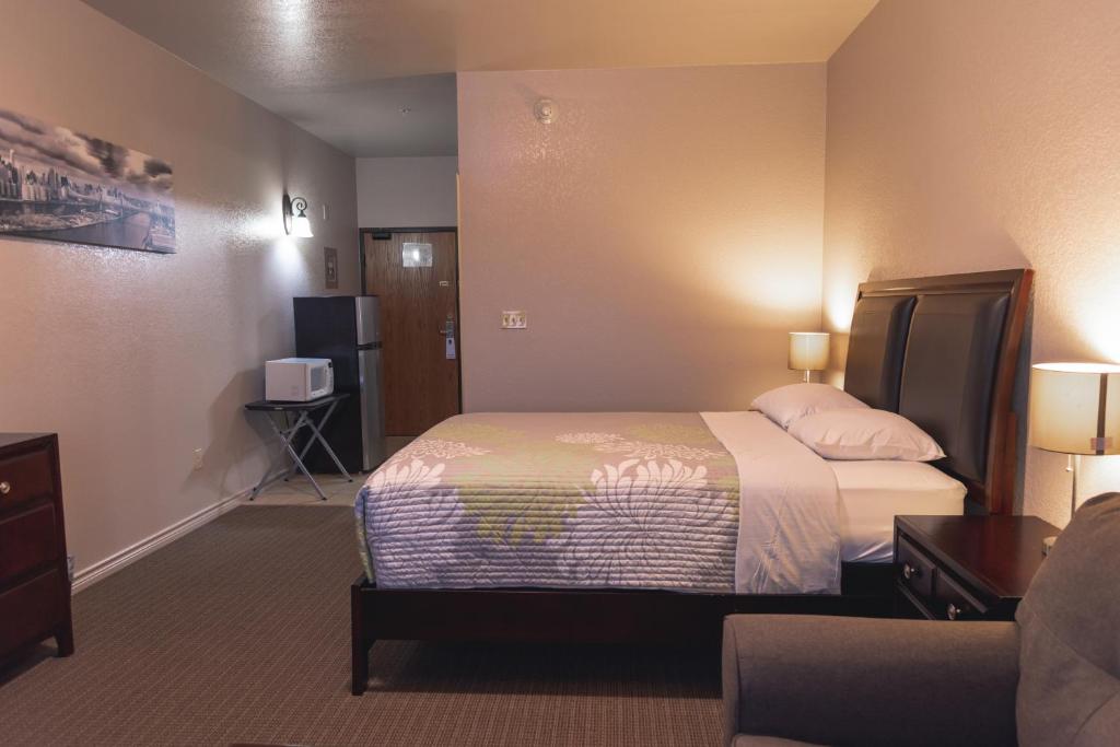 a hotel room with a bed and a couch at Premium Inn and Suites in Killeen