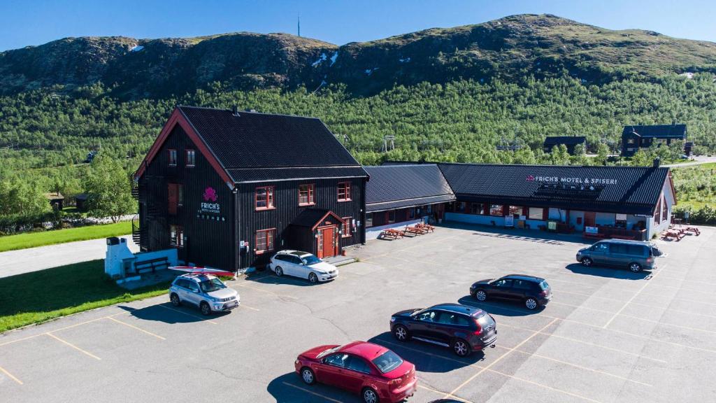 an aerial view of a building with cars parked in a parking lot at Frich`s Hjerkinnhus in Hjerkinn