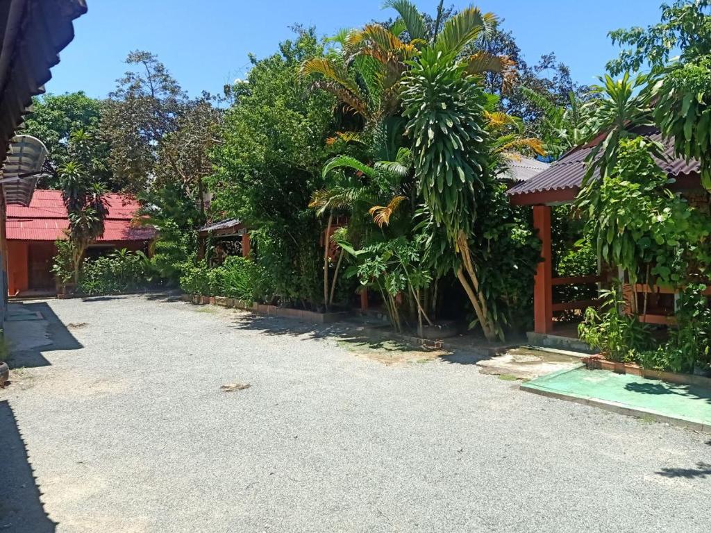 a house with a lot of trees and a driveway at Pina House in Kep
