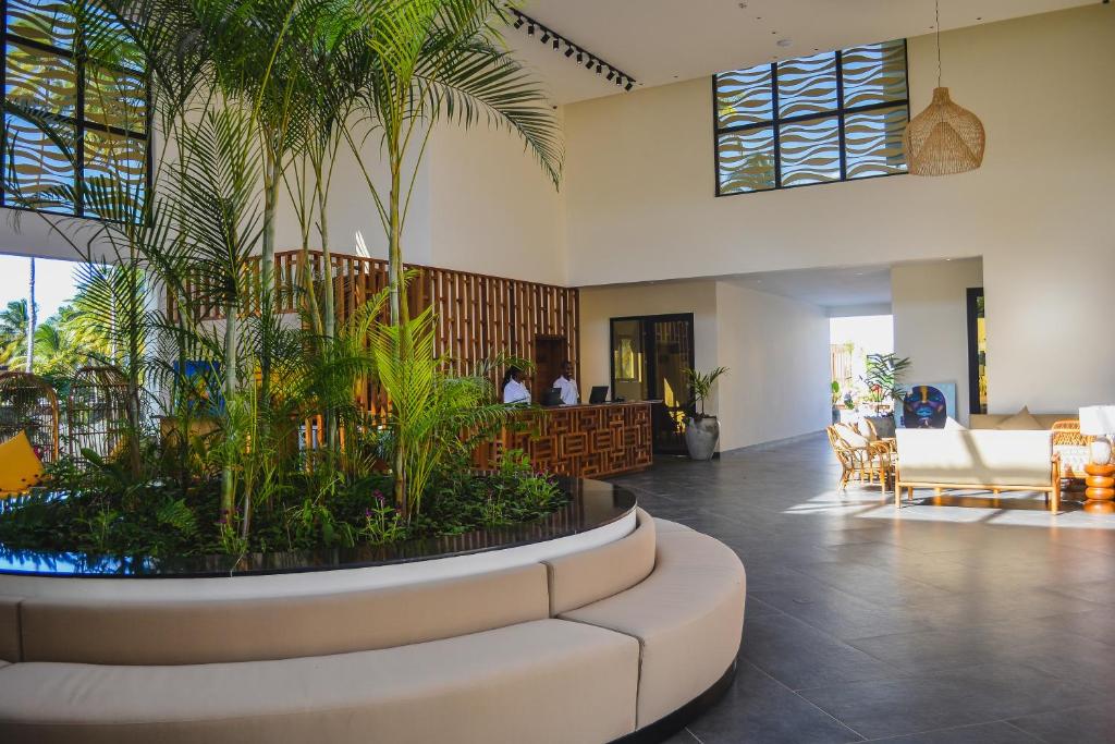 a lobby with a large planter with plants in it at TOA Hotel & Spa Zanzibar in Pongwe