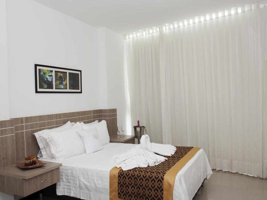 Postel nebo postele na pokoji v ubytování Hotel Cinco Monteria
