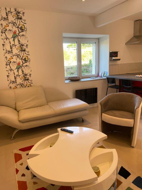a living room with a couch and a table at Duplex près de Nantes in Thouaré-sur-Loire